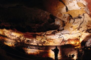 A man examining the Lascaux Cave paintings